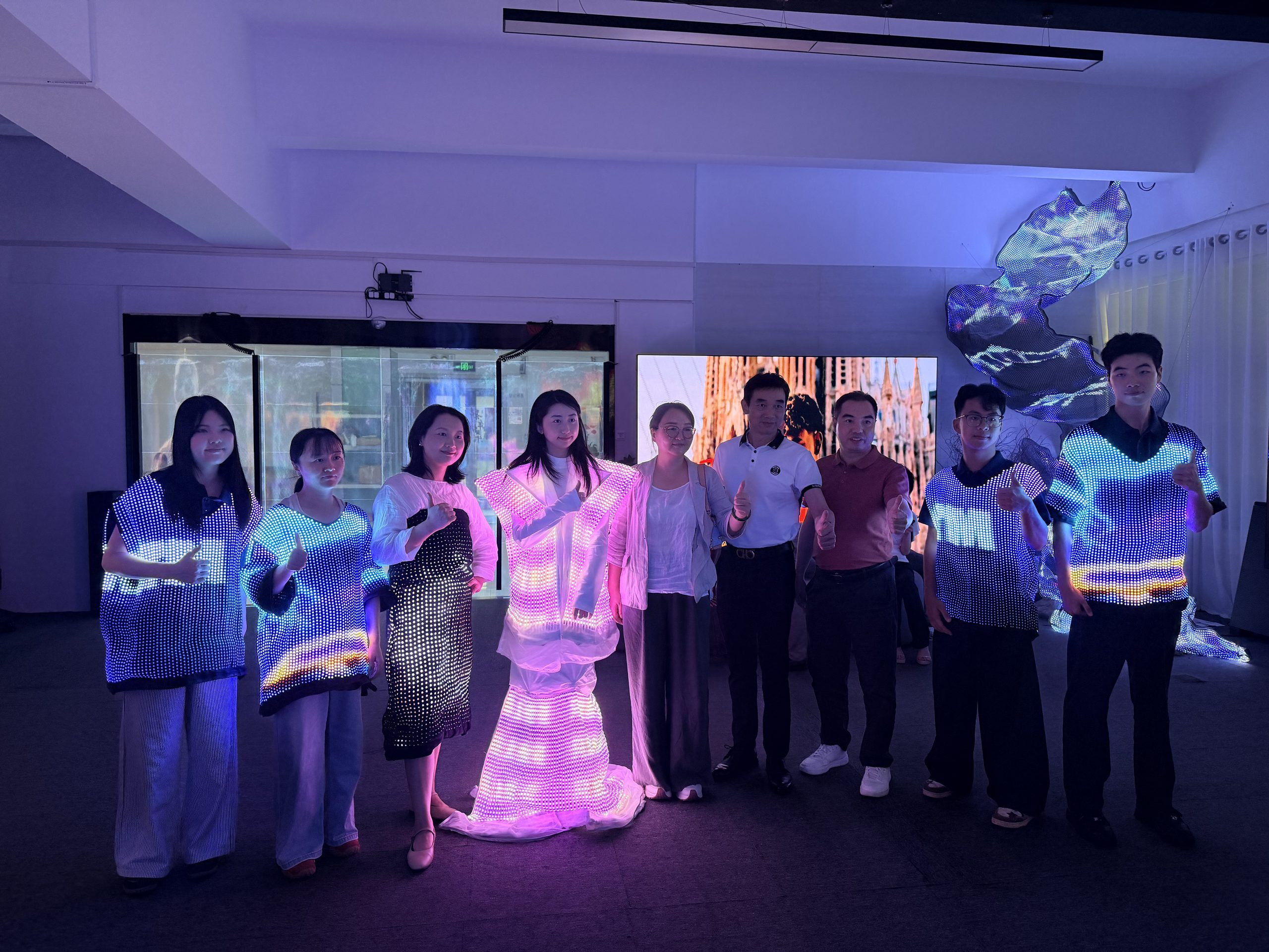 iDisplay team performing with wearable LED displays at its Shenzhen showroom